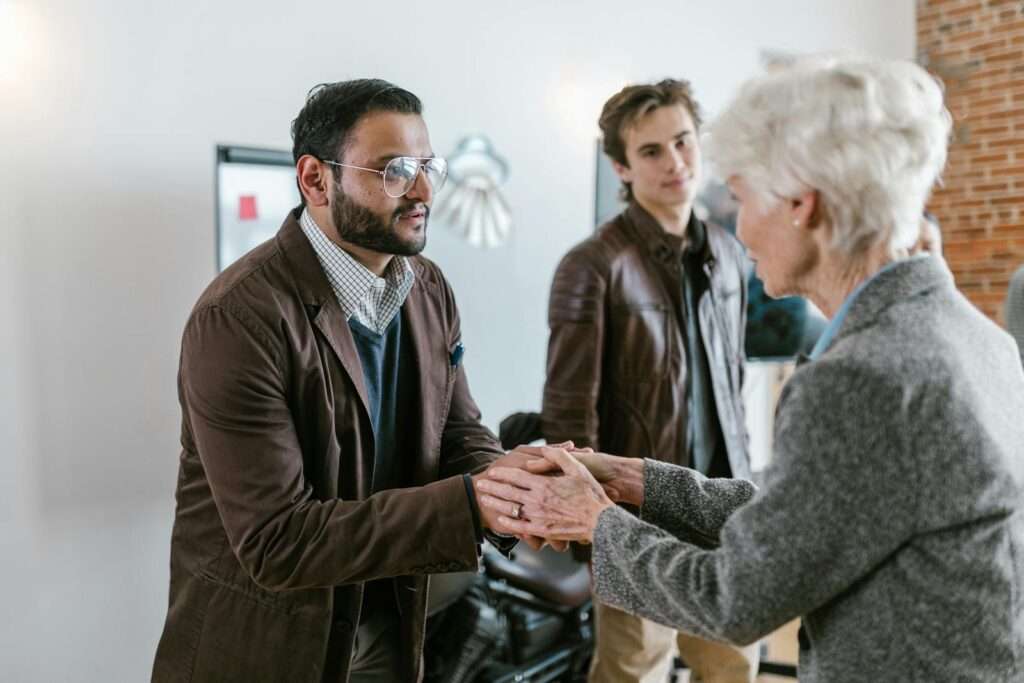 A diverse business team greeting with a handshake, representing cooperation and teamwork.